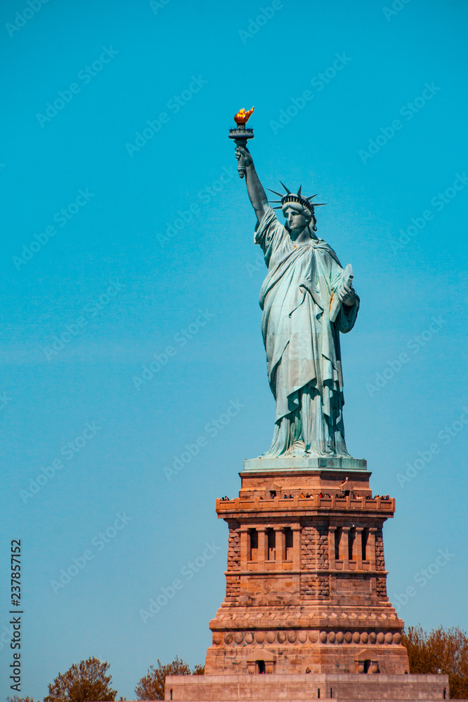 Fototapeta premium Teal and orange view of The Statue of Liberty Enlightening the World, Liberty Island, NYC