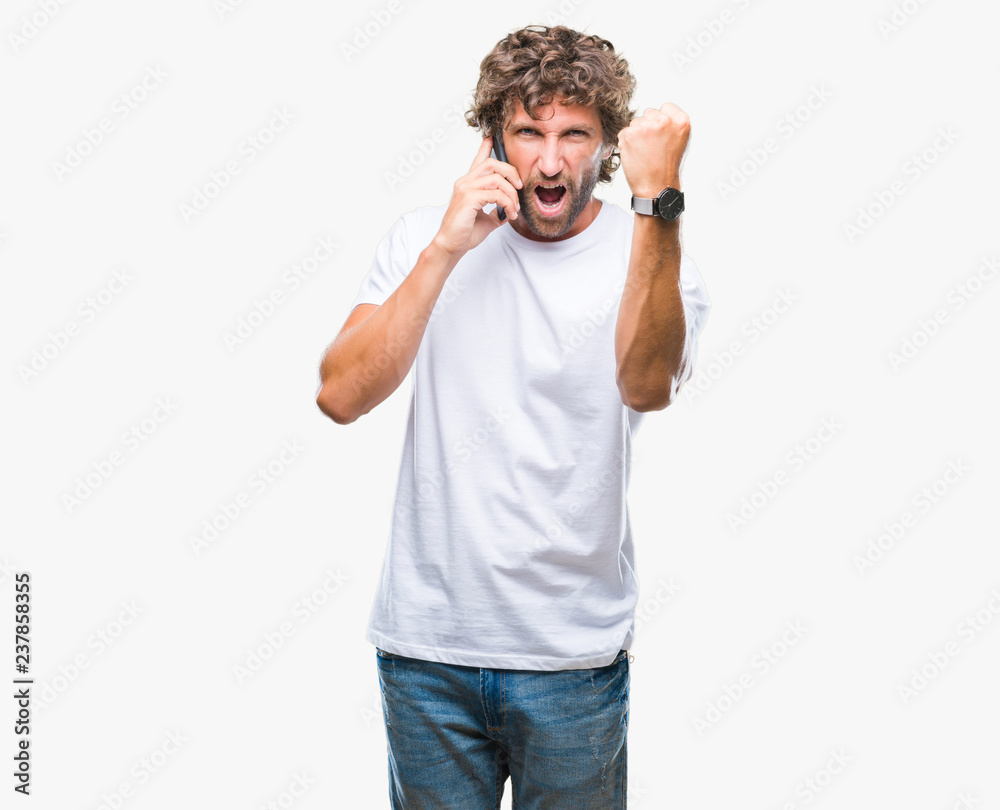 Fototapeta premium Handsome hispanic man model talking on smartphone over isolated background annoyed and frustrated shouting with anger, crazy and yelling with raised hand, anger concept
