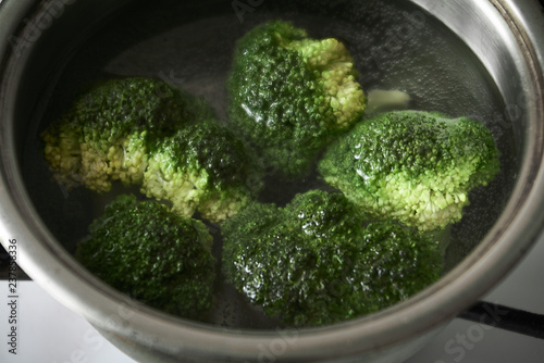Broccoli is cooked in metal pan. Close-up.