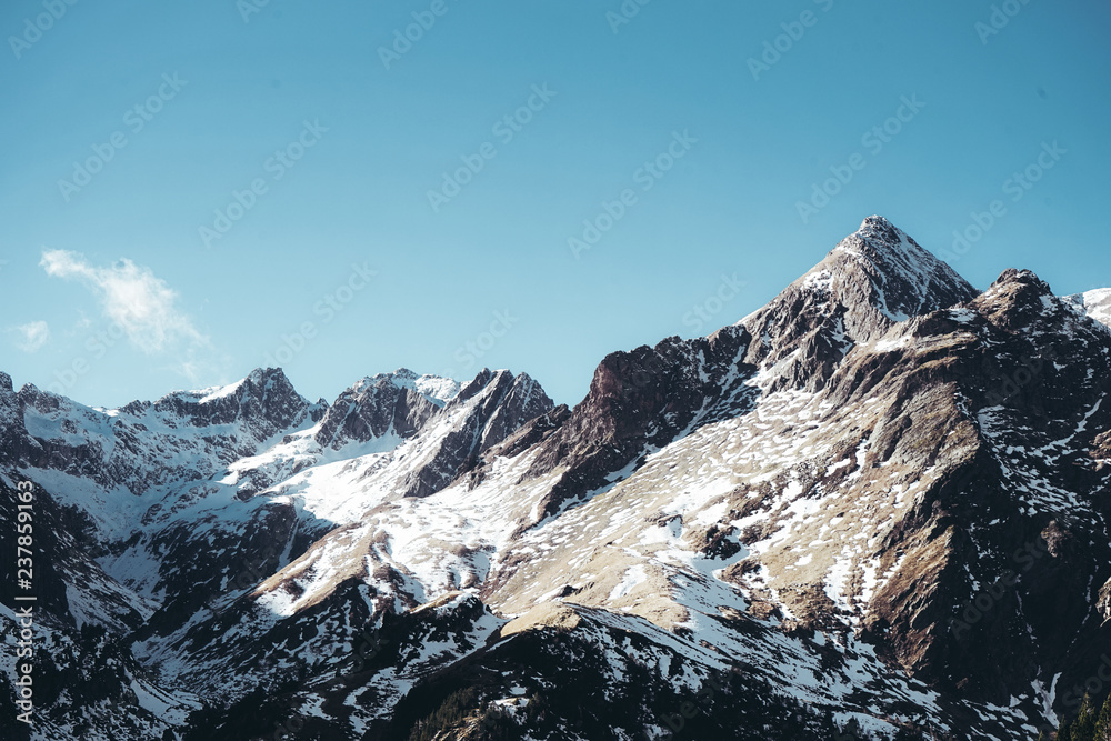 Snow covered mountain with a clear blue sky