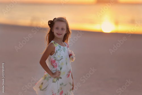 Portrait of pretty girl smiling at sunset on the sea