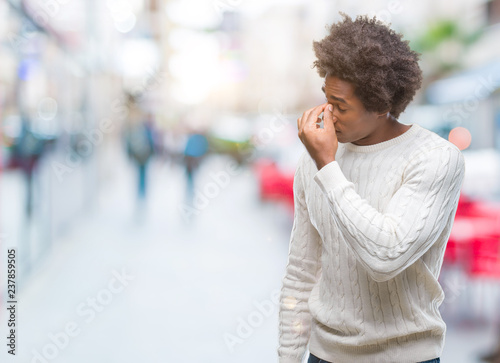 Afro american man over isolated background tired rubbing nose and eyes feeling fatigue and headache. Stress and frustration concept.