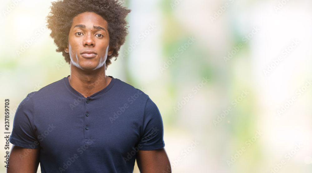 Afro american man over isolated background with serious expression on face. Simple and natural looking at the camera. Afro american man over isolated background with serious expression on face. Simple and natural looking at the camera.