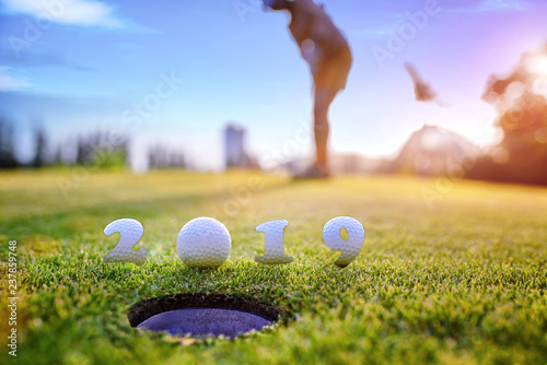 incoming year 2019, prepare by putting of woman golfer on the green, golfball mostly ready to drop into the hole of new year success, Happy new year and merry Christmas on golf course