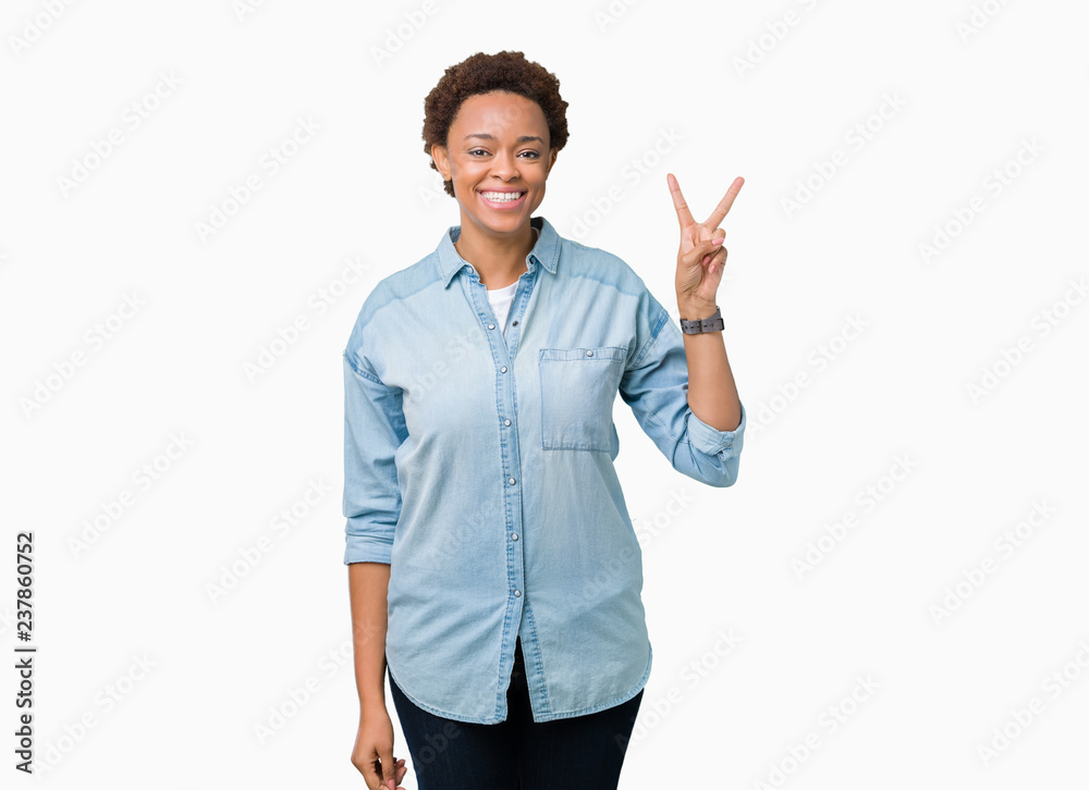 Young beautiful african american woman over isolated background smiling with happy face winking at the camera doing victory sign. Number two. Young beautiful african american woman over isolated background smiling with happy face winking at the camera doing victory sign. Number two.