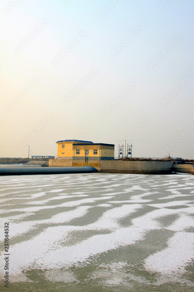 shores of an icy river and house shores of an icy river and house