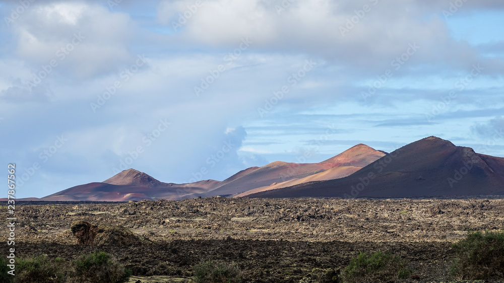 Beautiful volcanic landscape background. Mountain range with lava fields in the foreground.