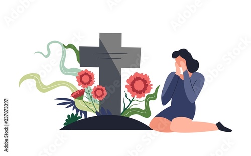 Funeral burial ceremony person sitting by tombstone and crying