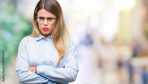 Free Download Young beautiful business woman wearing glasses over isolated background skeptic and nervous, disapproving expression on face with crossed arms. Negative person. - GFXLoad