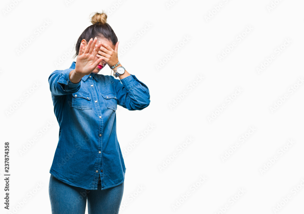 Young beautiful woman over isolated background covering eyes with hands and doing stop gesture with sad and fear expression. Embarrassed and negative concept. Young beautiful woman over isolated background covering eyes with hands and doing stop gesture with sad and fear expression. Embarrassed and negative concept.