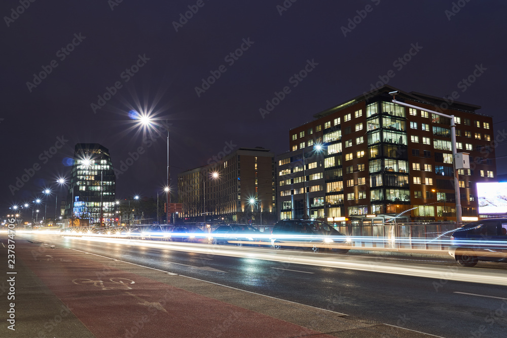 A modern office building and a night traffic in Poznan. A modern office building and a night traffic in Poznan.