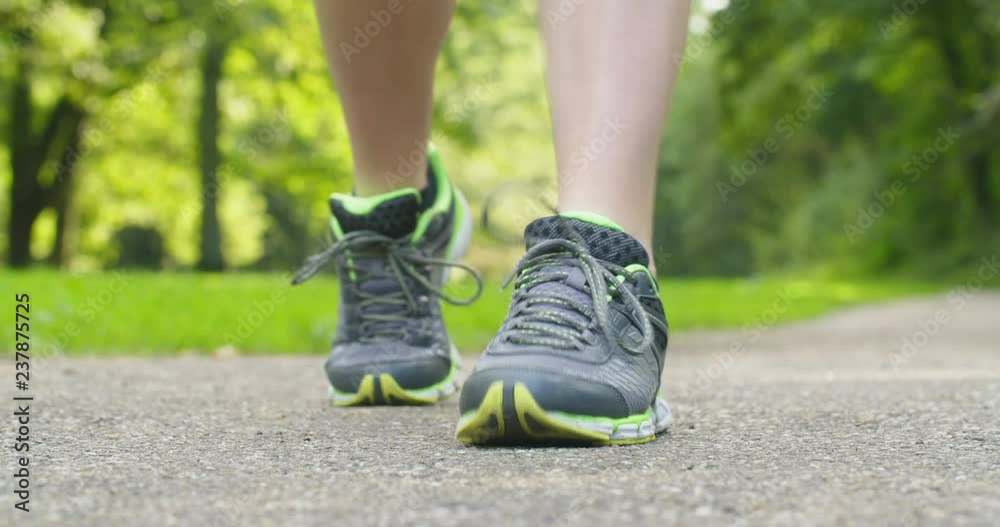 A woman jogging in a park - closeup shot of her feet.