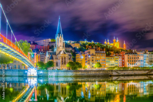 Night view of illuminated basilique de Notre-dame de Fourivere and Saint Georges church in Lyon, France photo