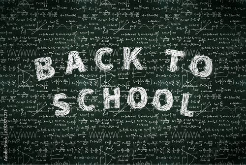A lot of basic math equations and formulas with back to school phrase, white chalk lettering on black chalkboard