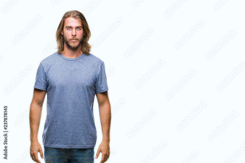 Fototapeta premium Young handsome man with long hair over isolated background with serious expression on face. Simple and natural looking at the camera.