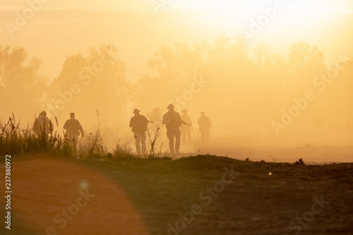 silhouette action soldiers walking hold weapons the background is smoke and sunset and white balance ship effect dark art style