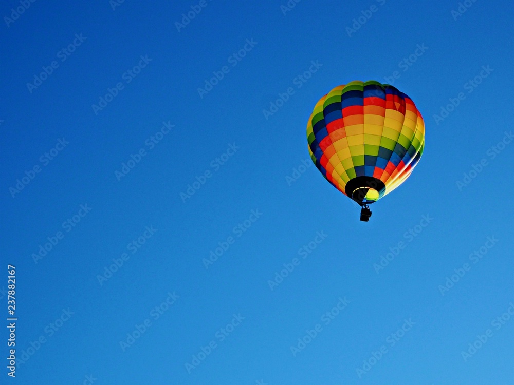 Colourful hot air balloon in a clear blue sky with copy space Colourful hot air balloon in a clear blue sky with copy space