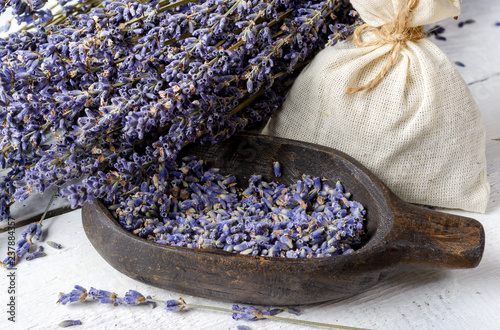 Fototapeta Naklejka Na Ścianę i Meble -  Dried lavender bunch and lavender flowers in wooden bowl.
