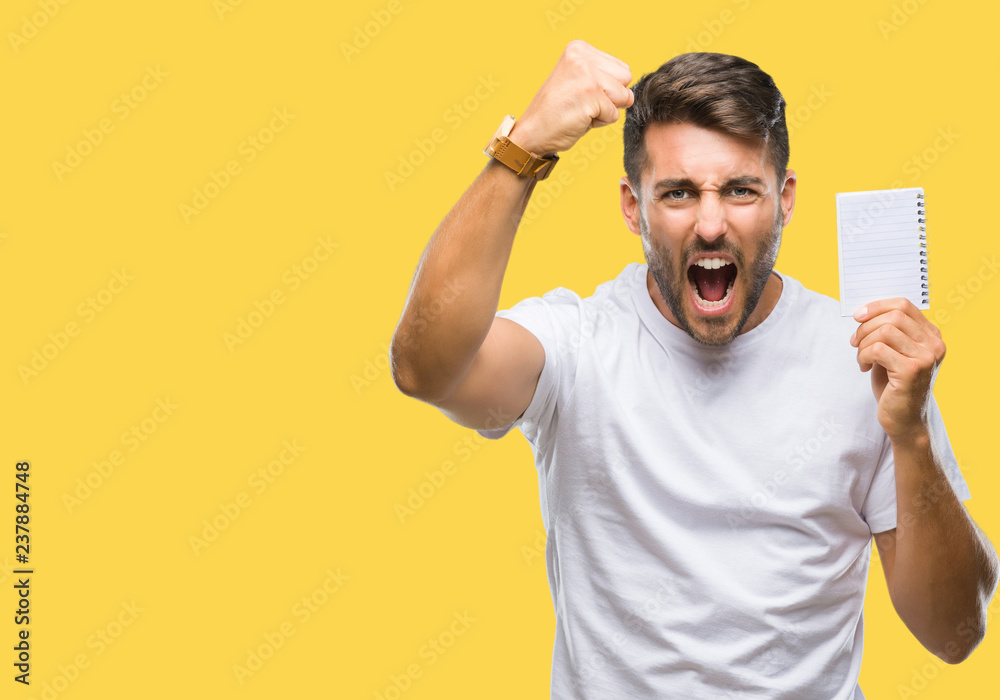 Young handsome man holding notebook over isolated background annoyed and frustrated shouting with anger, crazy and yelling with raised hand, anger concept Young handsome man holding notebook over isolated background annoyed and frustrated shouting with anger, crazy and yelling with raised hand, anger concept