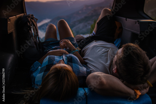 Enjoying the view on a peak of the mountain from inside the all terrain vehicle at sunset.