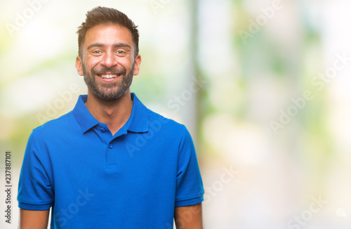 Adult hispanic man over isolated background with a happy and cool smile on face. Lucky person.
