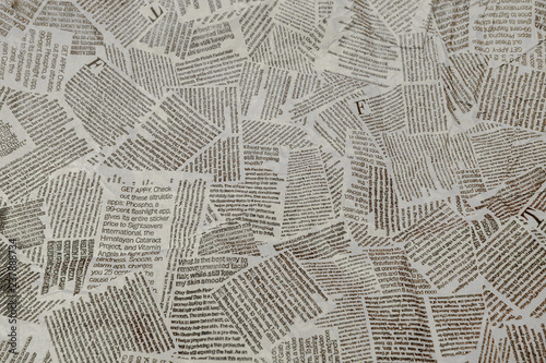 Black and white repeating torn newspaper background. Continuous pattern left, right, up and down photo