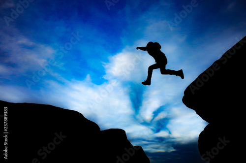 Boy Jumping between rocks