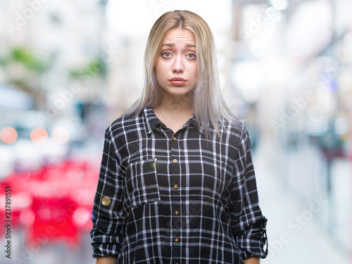 Young blonde woman over isolated background depressed and worry for distress, crying angry and afraid. Sad expression.