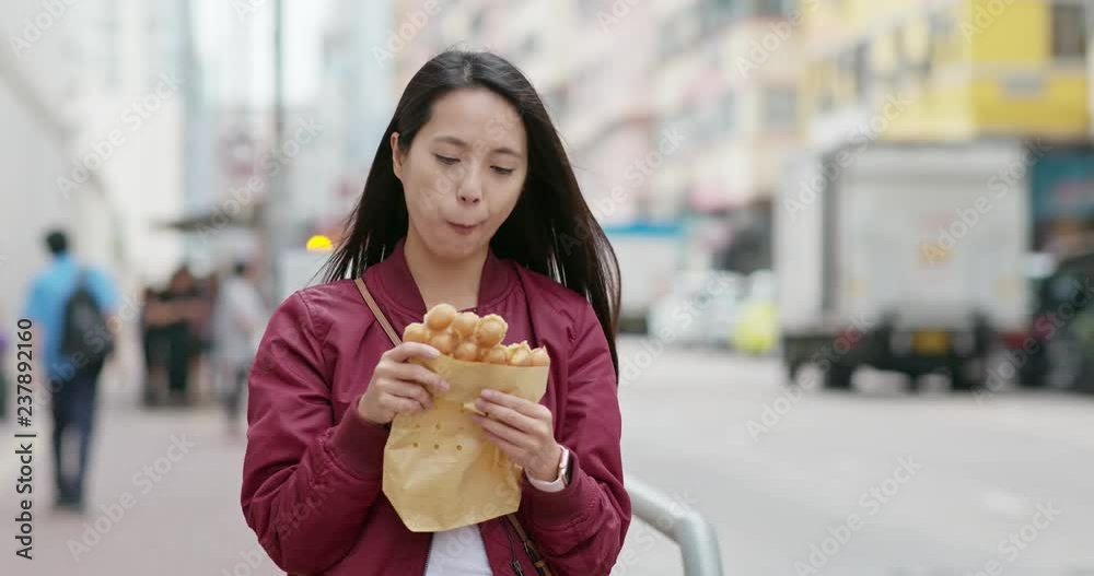 Woman eat local food, egg waffle in Hong Kong Woman eat local food, egg waffle in Hong Kong