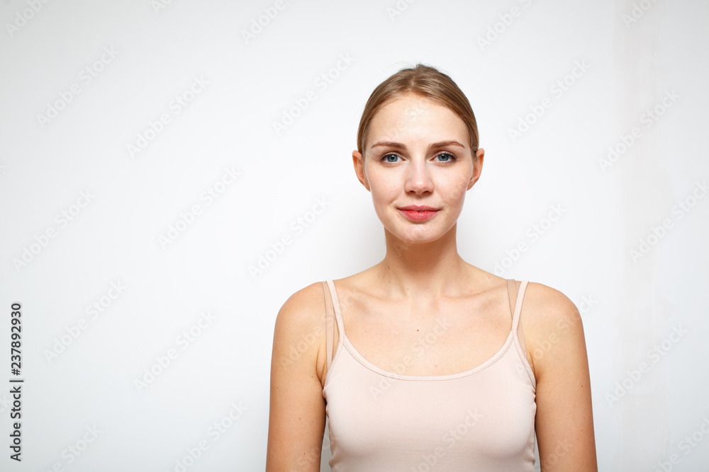 Portrait of young light smiling woman. Close up on white background Portrait of young light smiling woman. Close up on white background