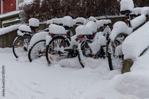 Left bikes under snow.