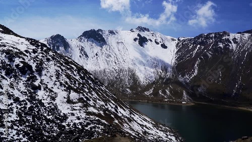 Panoramic motion of nice view of the nevado de toluca volcano also called xinantecatl which is rarely this snowy and its lagoon photo