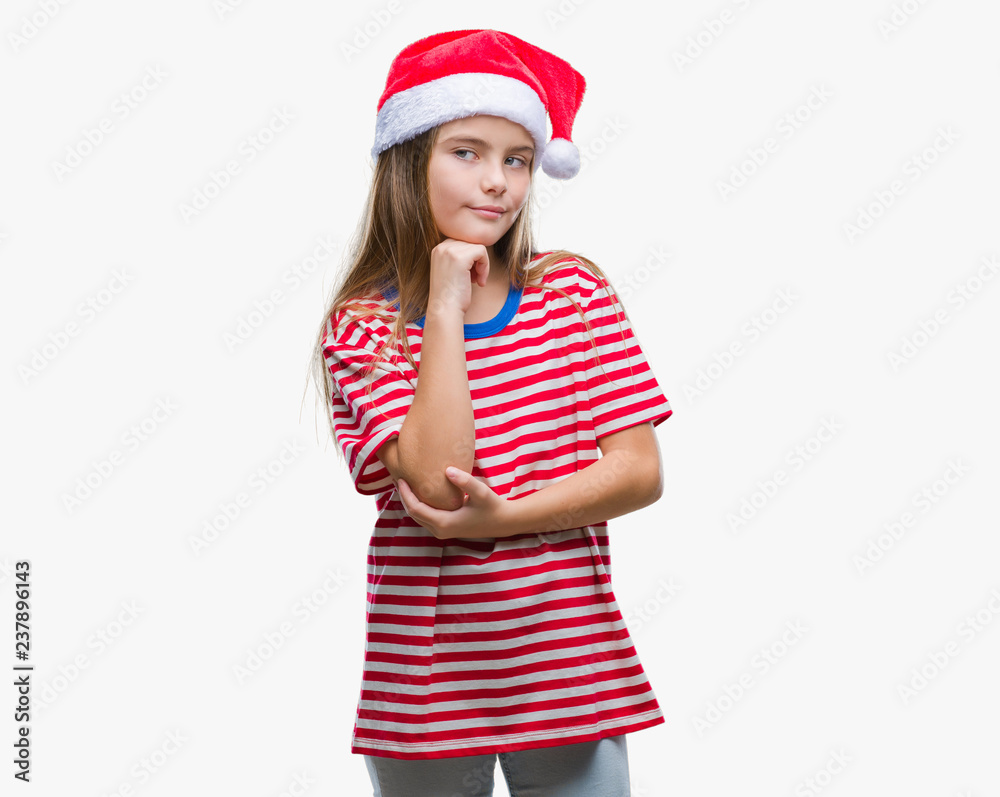 Young beautiful girl wearing christmas hat over isolated background with hand on chin thinking about question, pensive expression. Smiling with thoughtful face. Doubt concept. Young beautiful girl wearing christmas hat over isolated background with hand on chin thinking about question, pensive expression. Smiling with thoughtful face. Doubt concept.