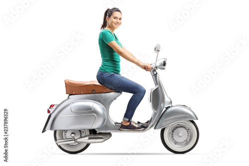 Young female riding a vintage scooter