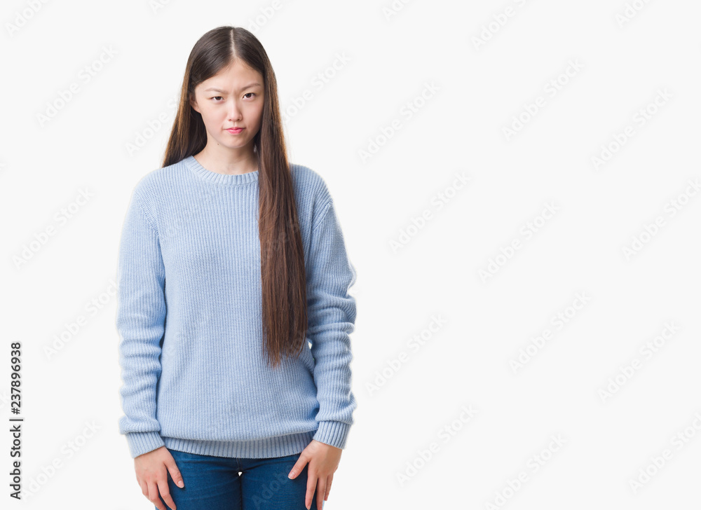 Young Chinese woman over isolated background skeptic and nervous, frowning upset because of problem. Negative person. Young Chinese woman over isolated background skeptic and nervous, frowning upset because of problem. Negative person.