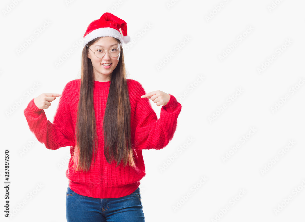 Young Chinese woman over isolated background wearing christmas hat looking confident with smile on face, pointing oneself with fingers proud and happy. Young Chinese woman over isolated background wearing christmas hat looking confident with smile on face, pointing oneself with fingers proud and happy.