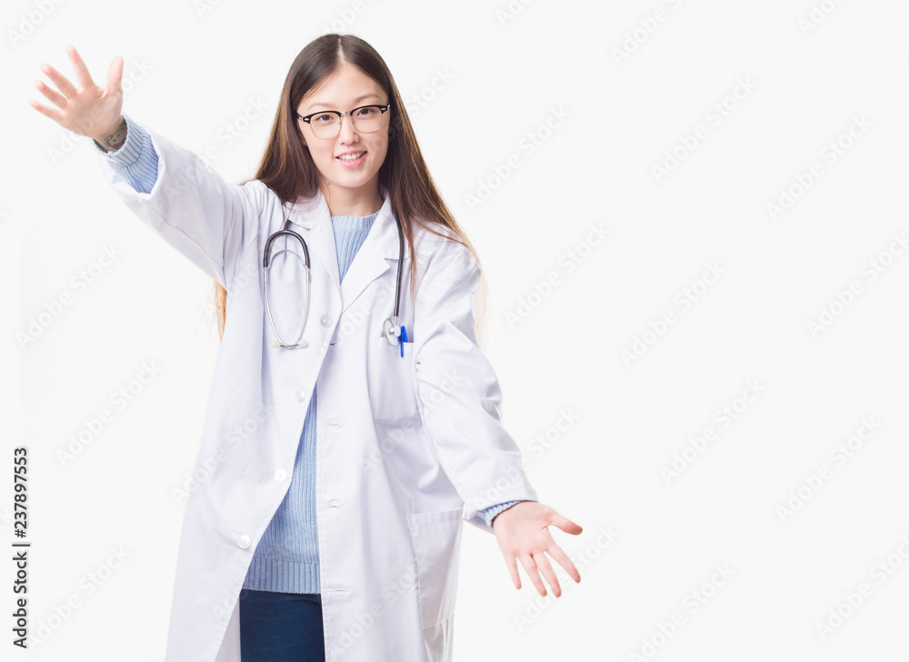 Young Chinese doctor woman over isolated background looking at the camera smiling with open arms for hug. Cheerful expression embracing happiness. Young Chinese doctor woman over isolated background looking at the camera smiling with open arms for hug. Cheerful expression embracing happiness.