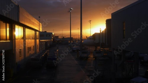 Auckland Airport domestic flight terminal with beautiful orange sky photo