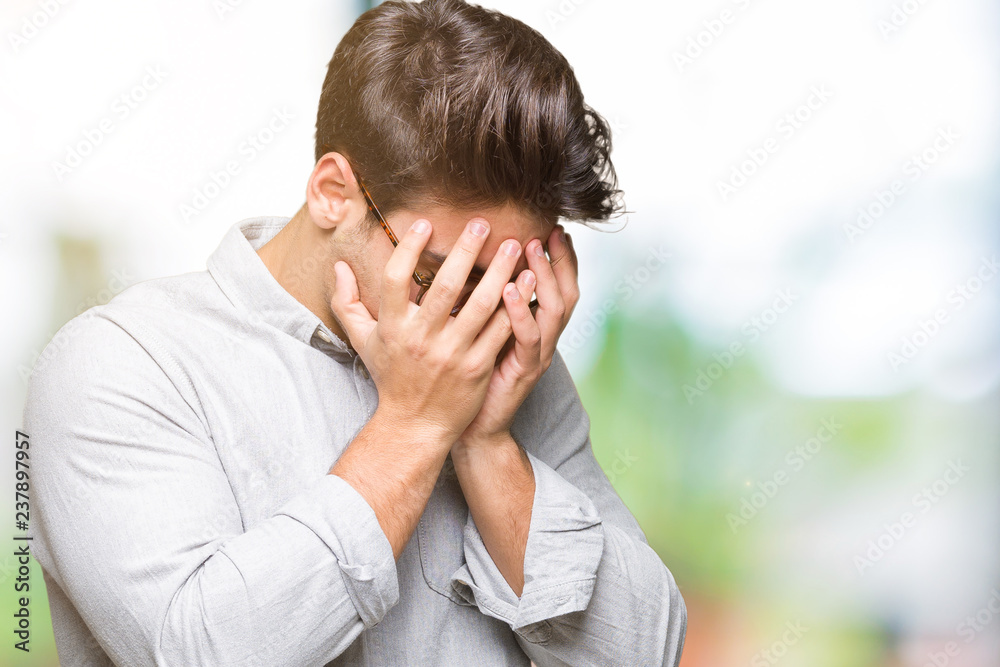 Young handsome man wearing glasses over isolated background with sad expression covering face with hands while crying. Depression concept. Young handsome man wearing glasses over isolated background with sad expression covering face with hands while crying. Depression concept.