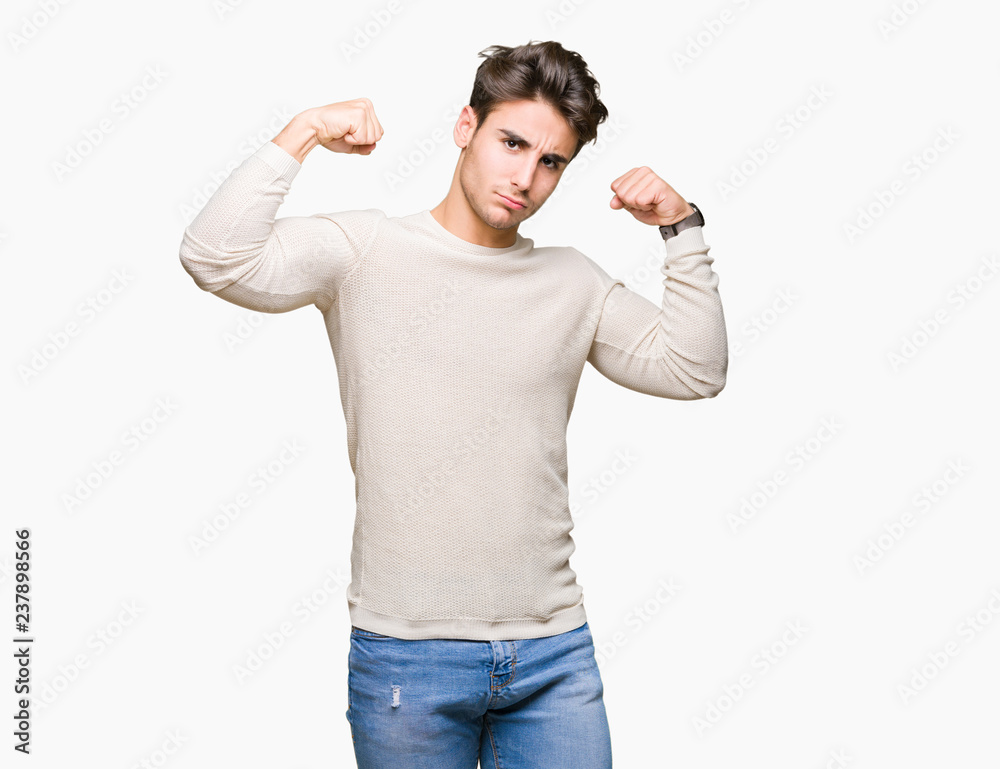 Young handsome man over isolated background showing arms muscles smiling proud. Fitness concept. Young handsome man over isolated background showing arms muscles smiling proud. Fitness concept.