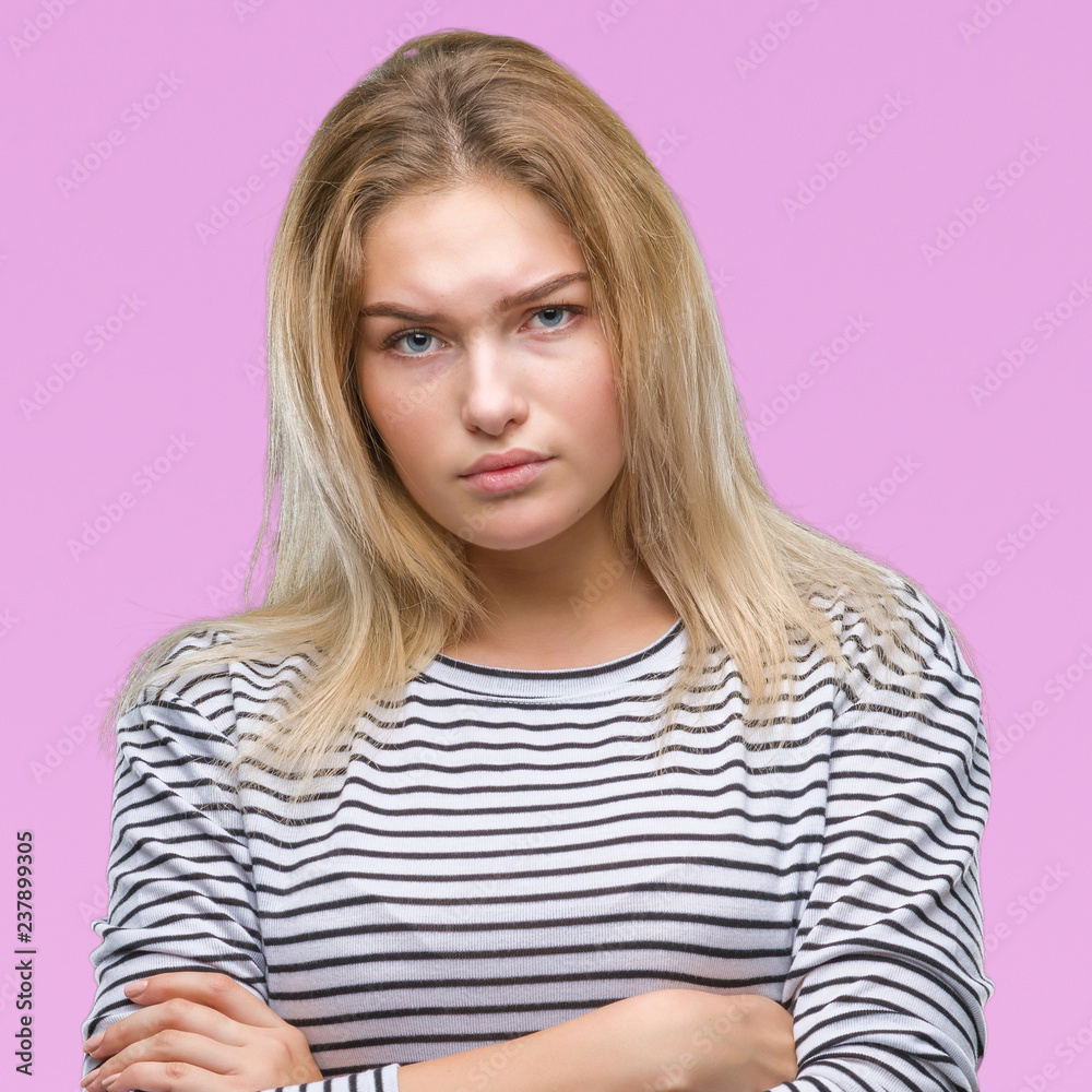Young caucasian woman over isolated background skeptic and nervous, disapproving expression on face with crossed arms. Negative person. Young caucasian woman over isolated background skeptic and nervous, disapproving expression on face with crossed arms. Negative person.