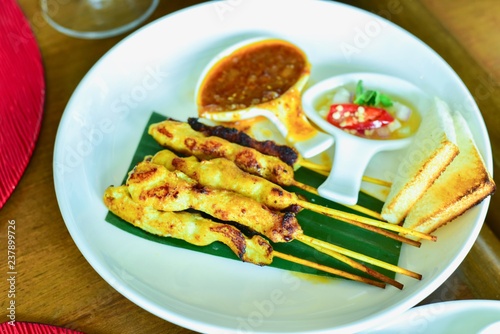 Close-Up View of Pork Satay With Thai Spices and Peanut Sauce