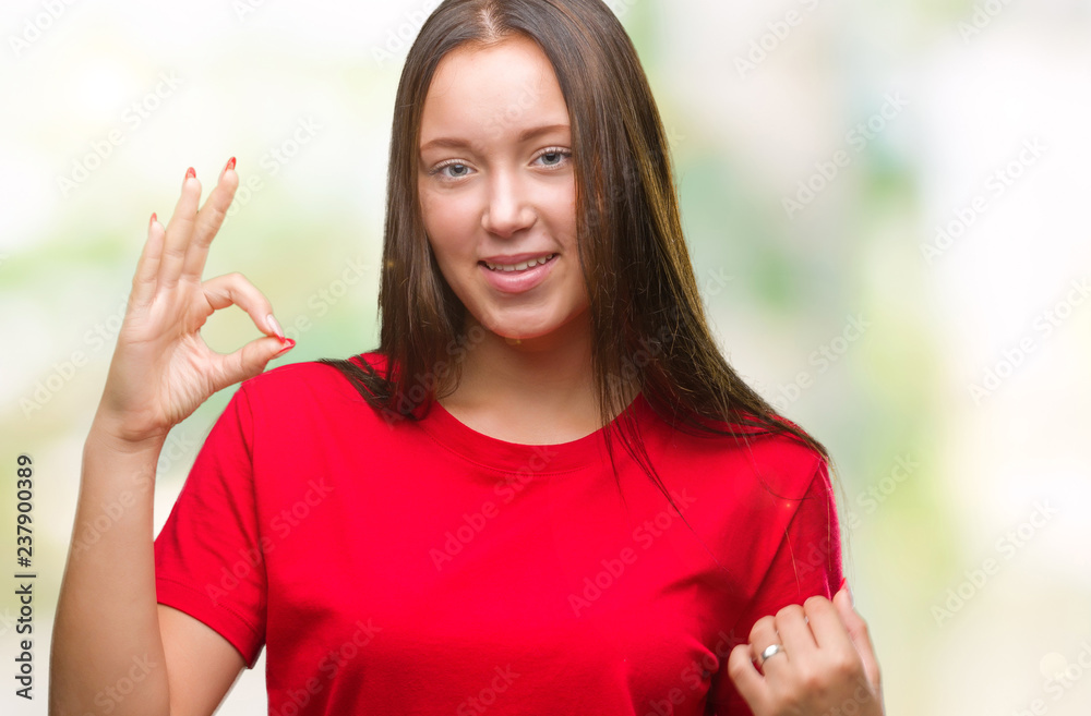 Young beautiful caucasian woman over isolated background smiling positive doing ok sign with hand and fingers. Successful expression. Young beautiful caucasian woman over isolated background smiling positive doing ok sign with hand and fingers. Successful expression.