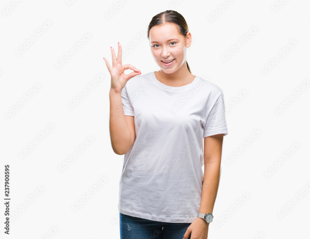 Young beautiful caucasian woman over isolated background smiling positive doing ok sign with hand and fingers. Successful expression. Young beautiful caucasian woman over isolated background smiling positive doing ok sign with hand and fingers. Successful expression.