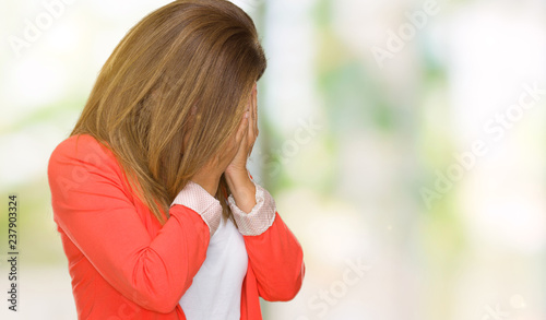 Beautiful middle age business adult woman over isolated background with sad expression covering face with hands while crying. Depression concept.