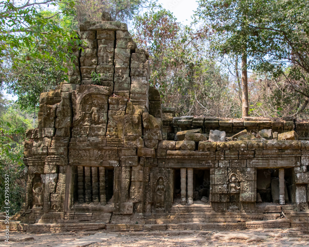 The temple is partially recovered from the jungle. Many ruins have been reconstructed some remain a jumble of stone with trees growing through the site