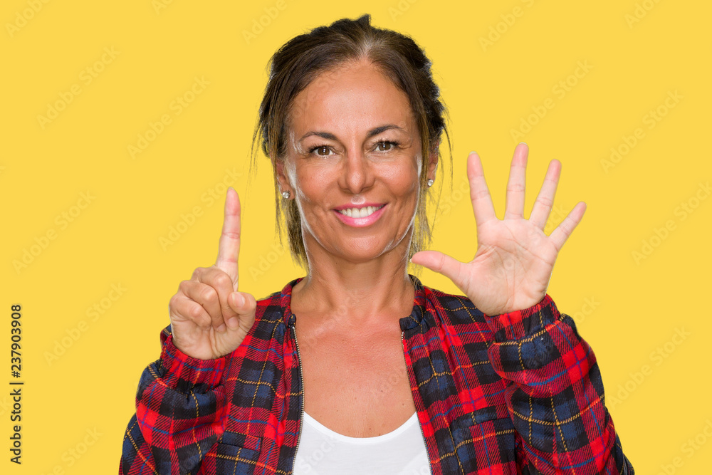 Middle age adult woman wearing casual jacket over isolated background showing and pointing up with fingers number six while smiling confident and happy. Middle age adult woman wearing casual jacket over isolated background showing and pointing up with fingers number six while smiling confident and happy.