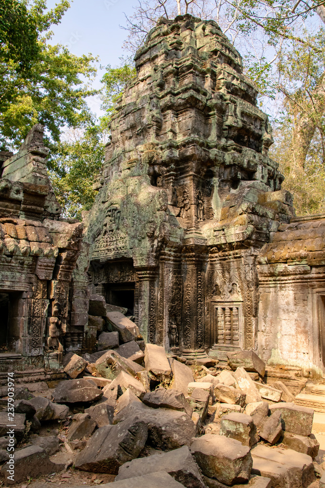 The temple is partially recovered from the jungle. Many ruins have been reconstructed some remain a jumble of stone with trees growing through the site