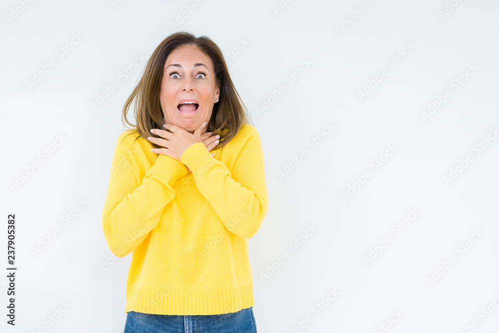 Beautiful middle age woman wearing yellow sweater over isolated background shouting and suffocate because painful strangle. Health problem. Asphyxiate and suicide concept. Beautiful middle age woman wearing yellow sweater over isolated background shouting and suffocate because painful strangle. Health problem. Asphyxiate and suicide concept.