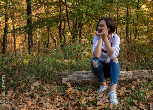 Girl Sitting on a Tree Log